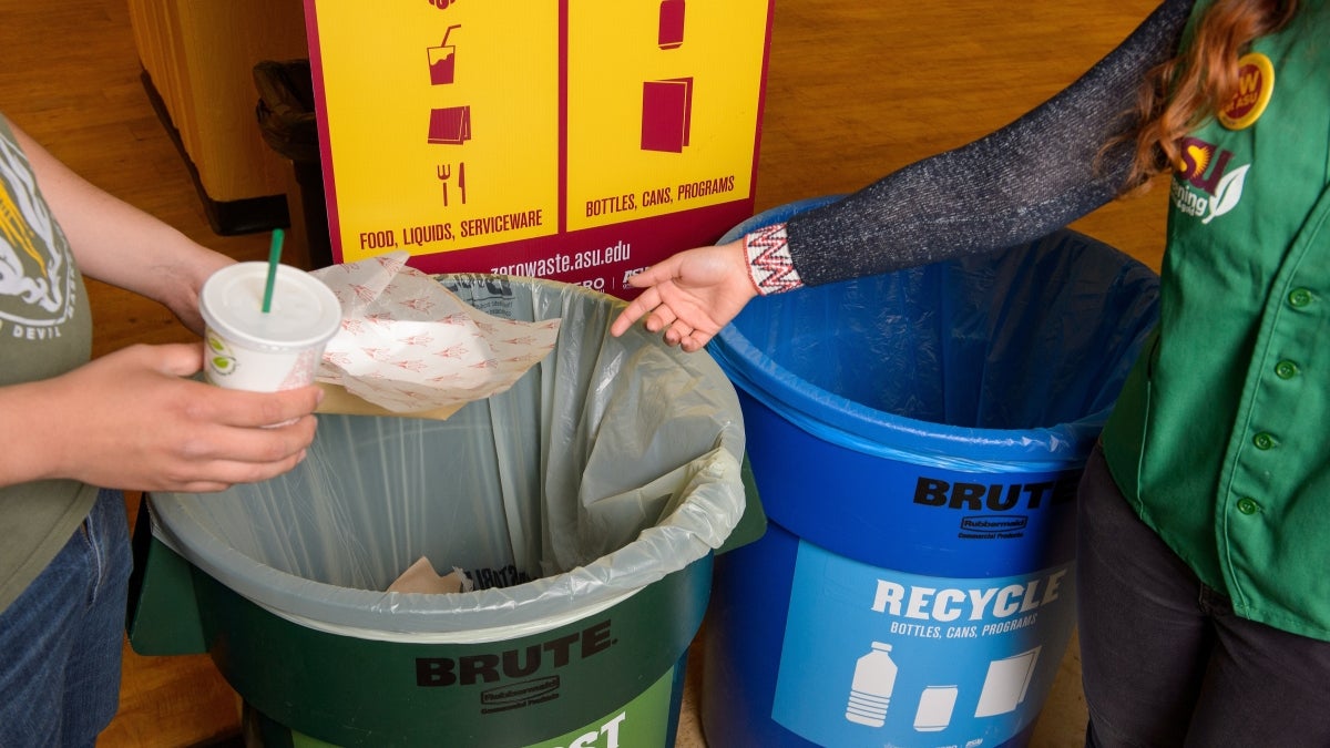 people putting items in recycle bins