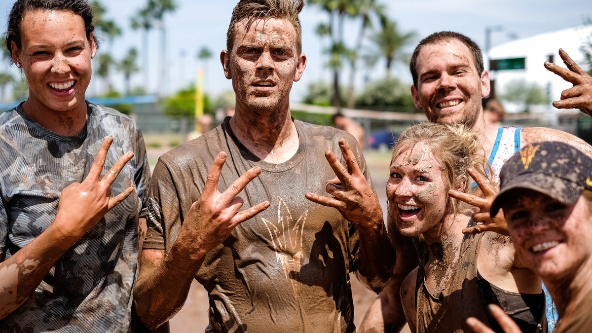 People muddy and posing.