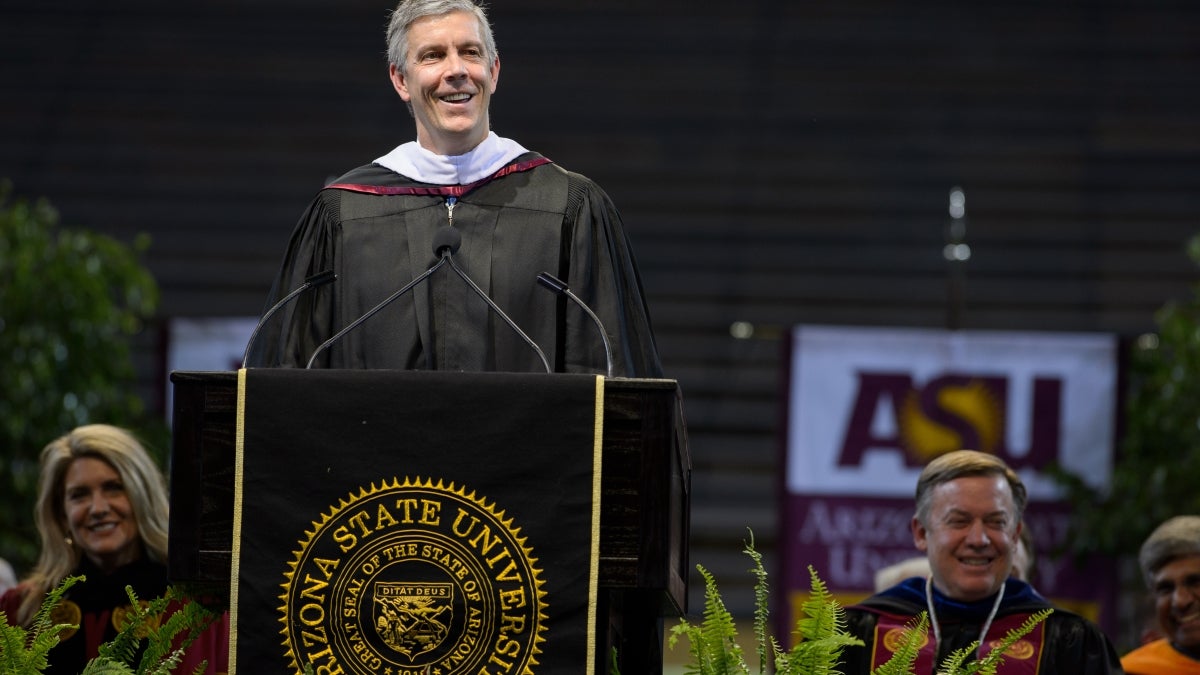 Arne Duncan speaking at podium during ASU undergraduate commencement