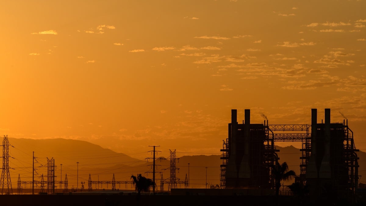 An industrial area is shown against the sunset sky.