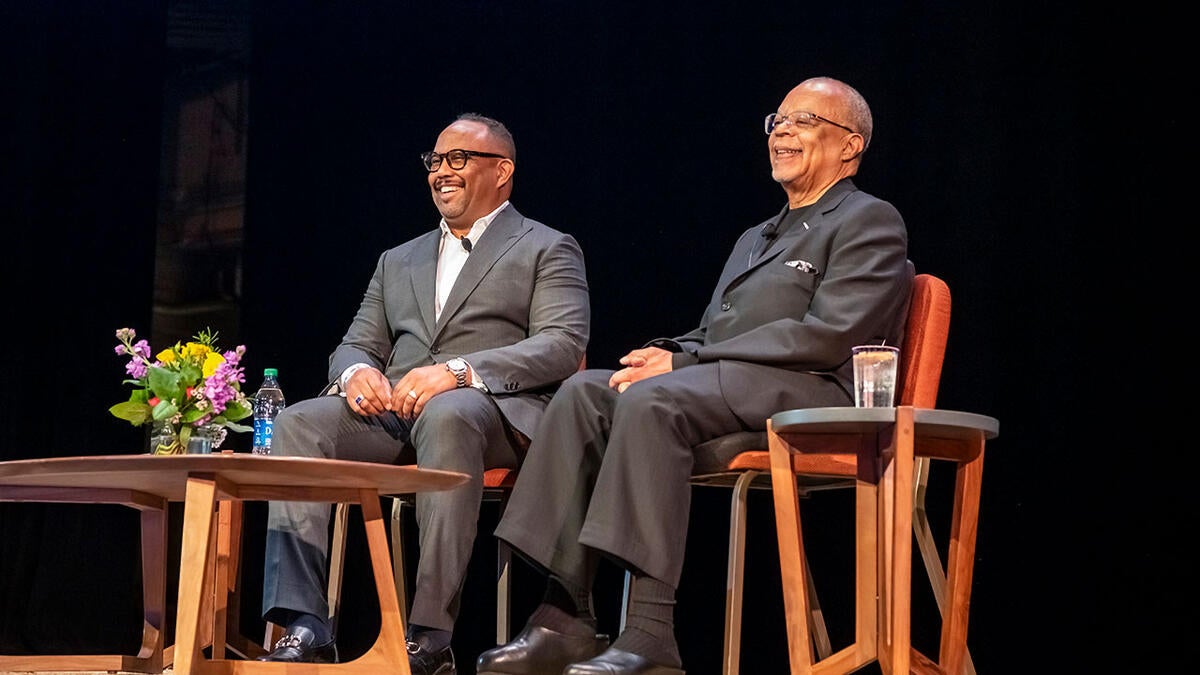 Henry Louis Gates Jr. and Cronkite School Dean Battinto L. Batts Jr. seated in chairs on a stage.