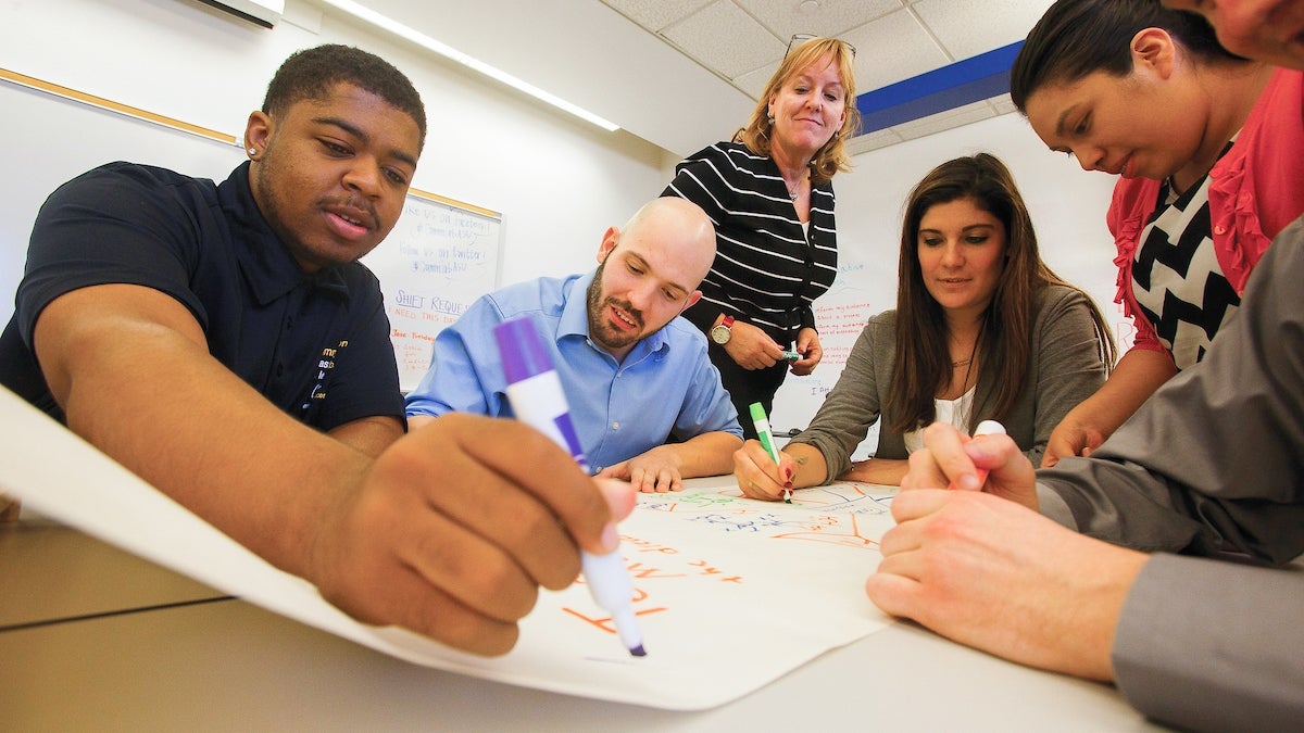 group of faculty interacting with students