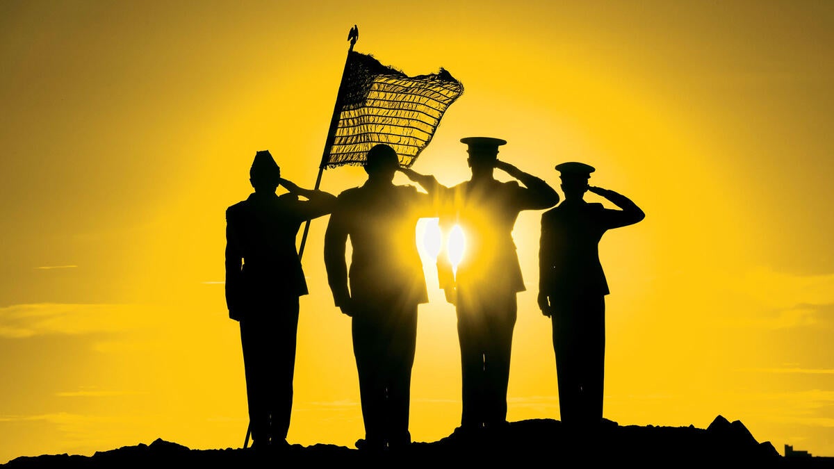 Four saluting military members are silhouetted against a setting sun