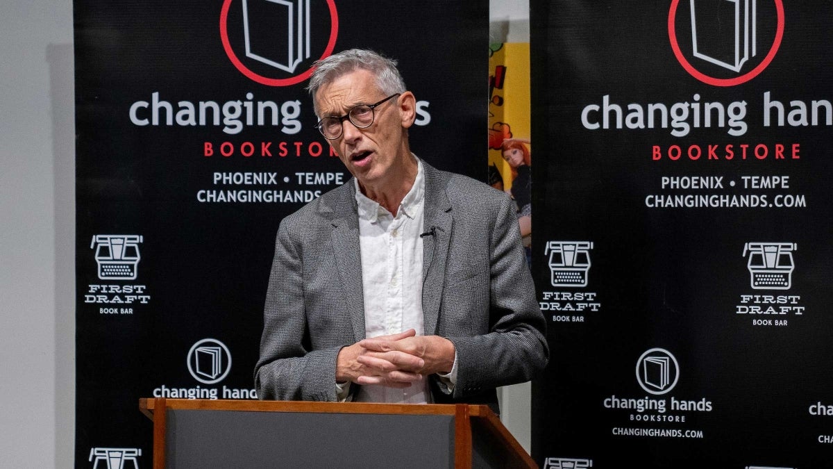 Sir Jonathan Bate speaks at a lectern at Changing Hands