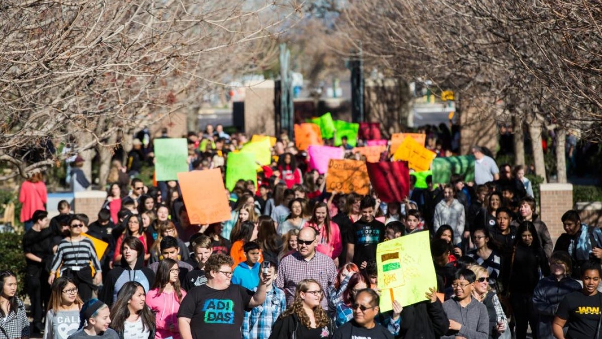 Students marching on ASU's West campus