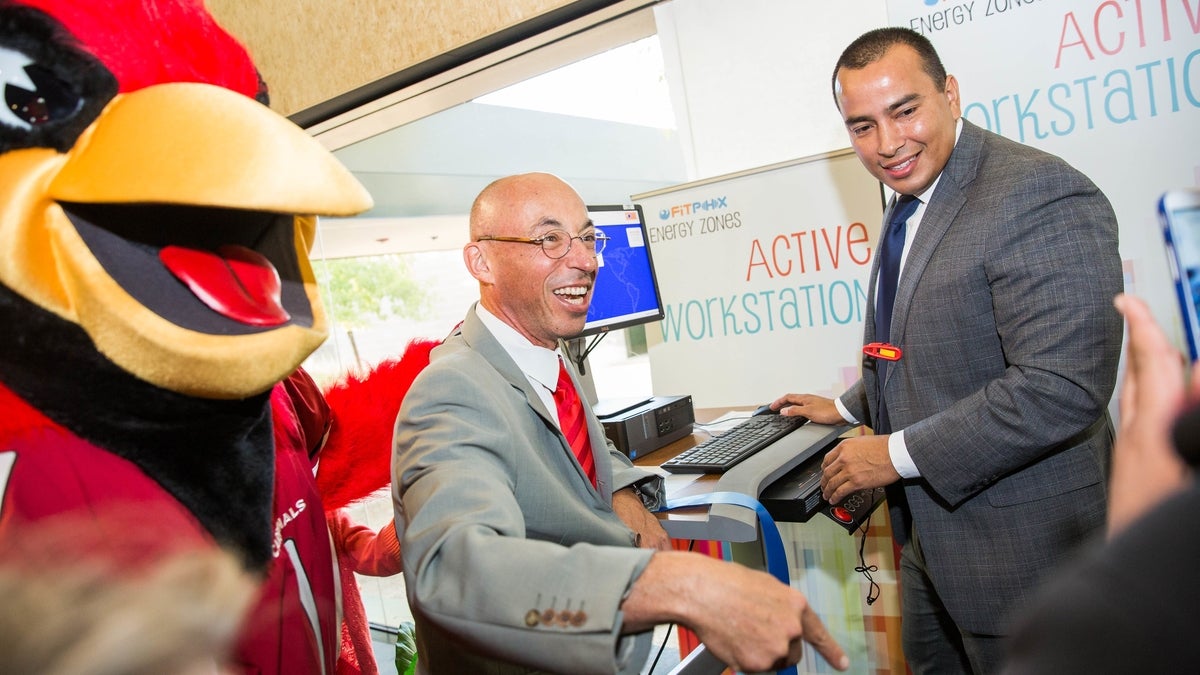 Men and a big bird at a treadmill desk