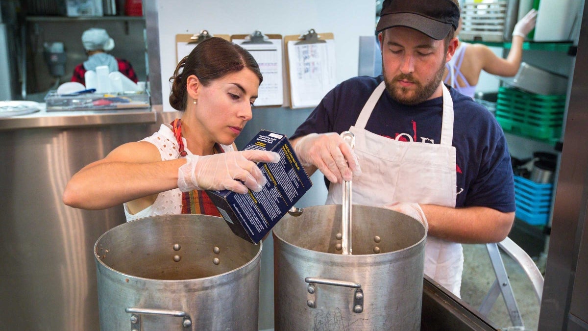 two people making soup