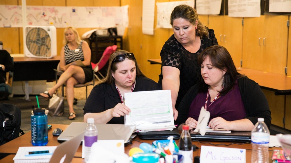 Nicole Aveni assists her students Melissa Sullivan, left, Hillary Golson, right, during their course at Longview School 