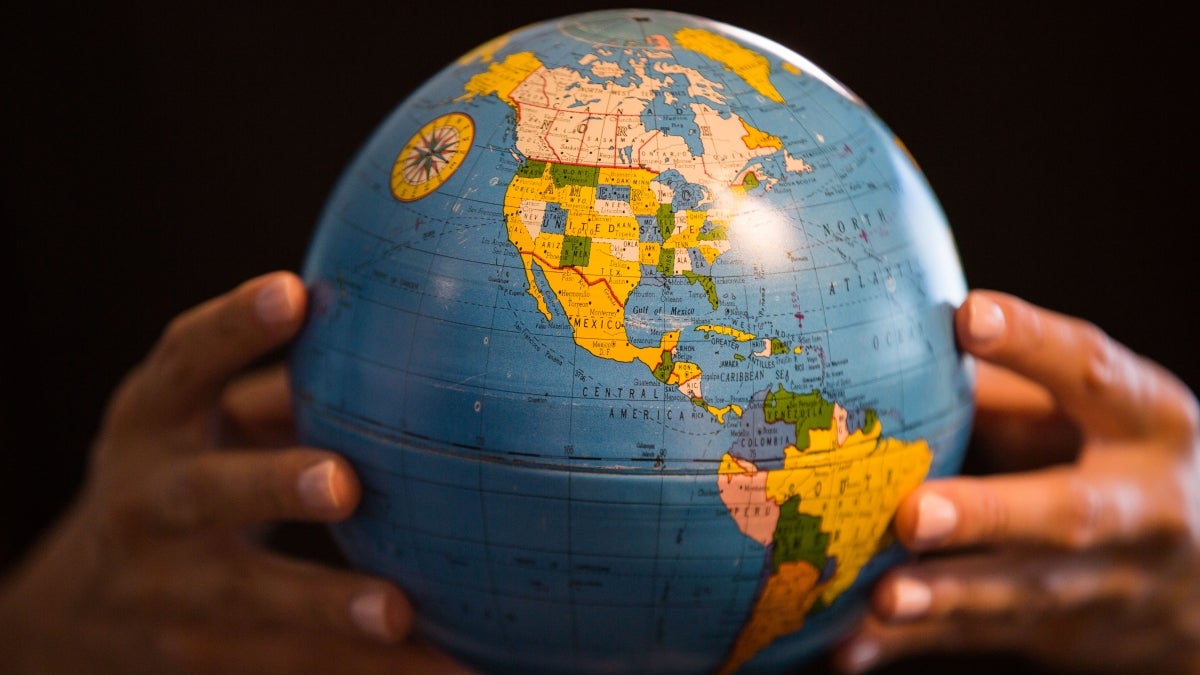 Hands holding a globe