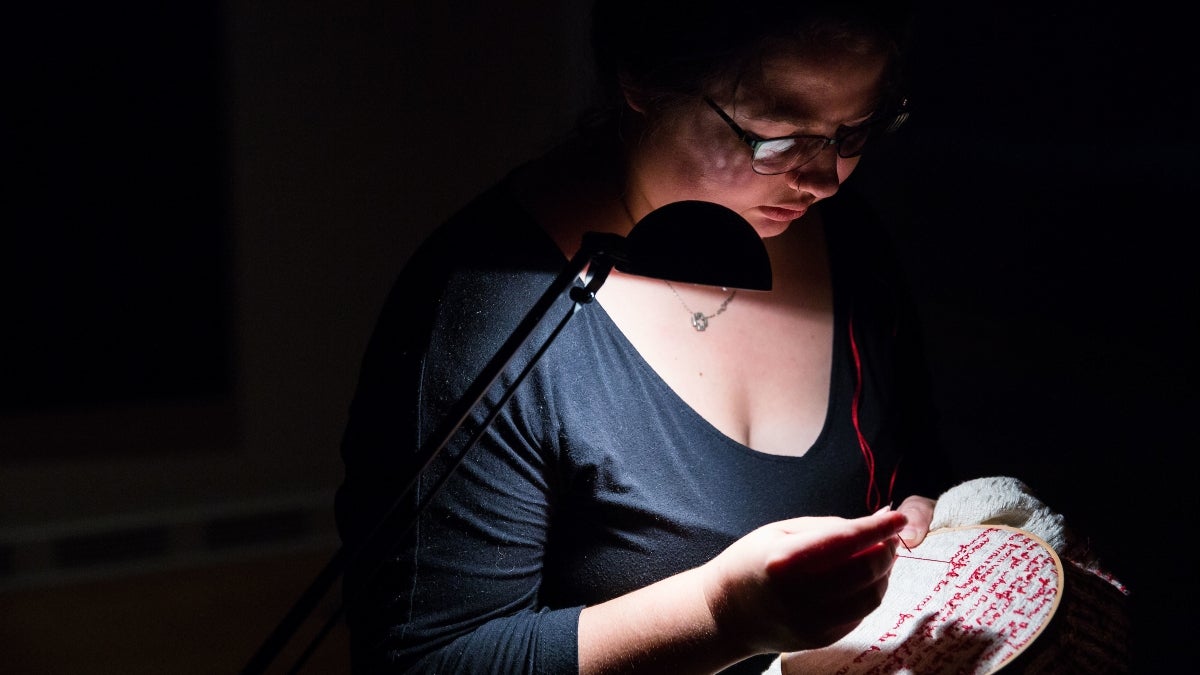 person embroidering 