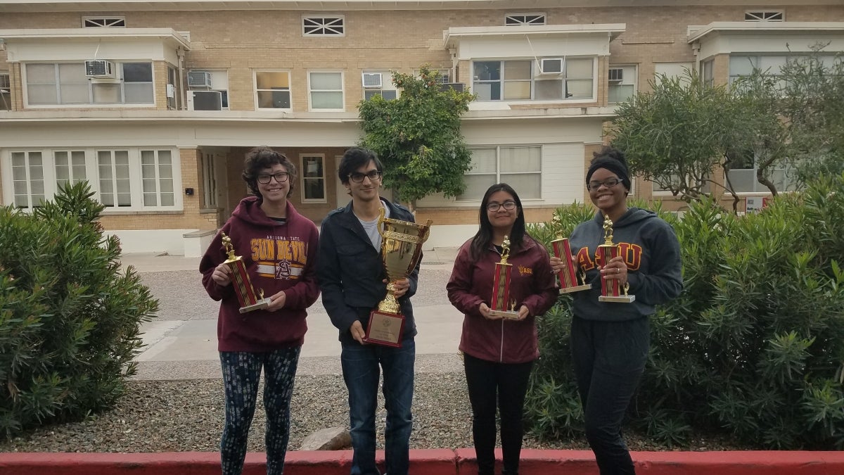 students holding trophies