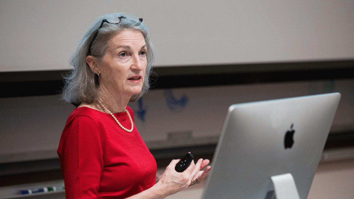 Kathleen Thelen of MIT speaks at a lectern with a computer monitor