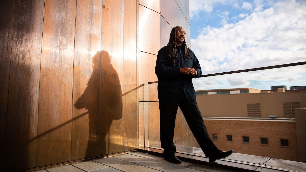 Black man standing near balcony