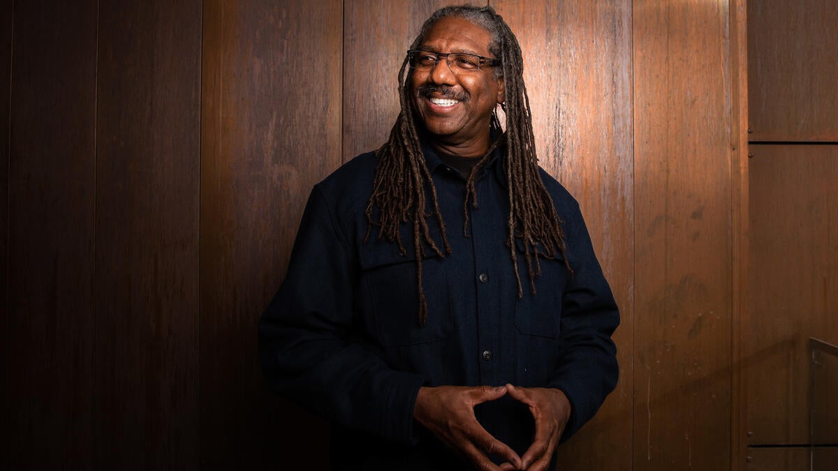 Portrait of ASU Professor Neal Lester against a copper background