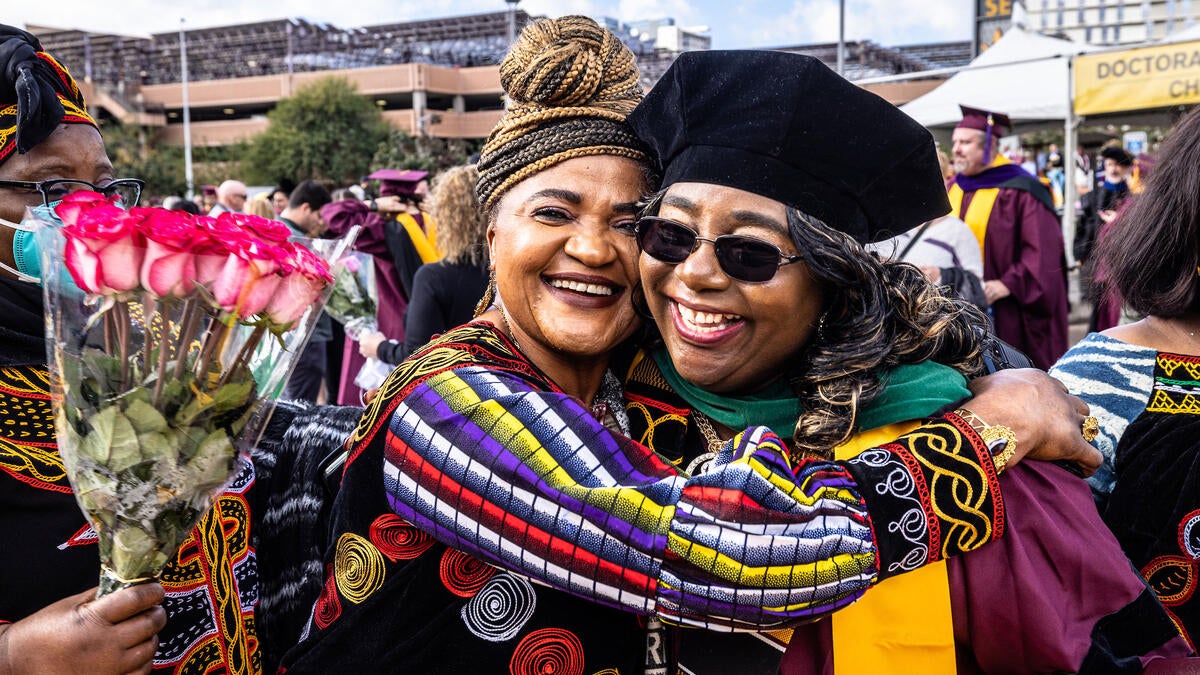 Friend hugging recent ASU graduate