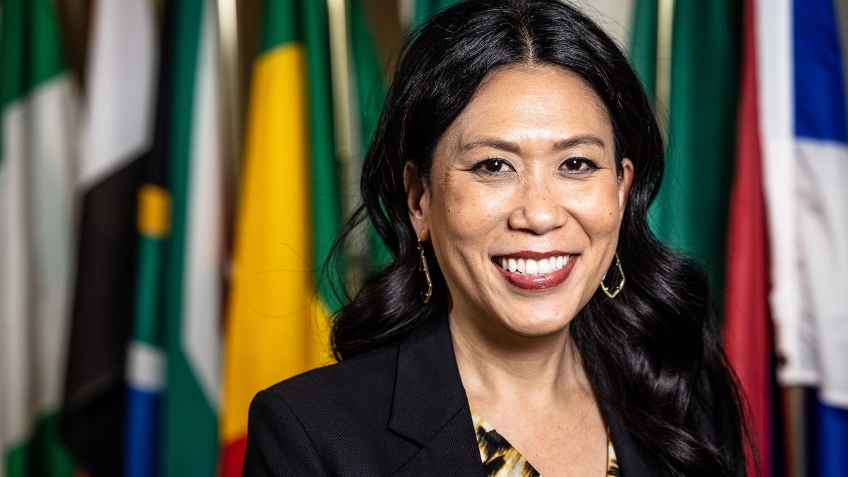 woman's portrait in front of international flags