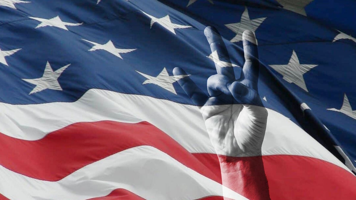 A hand holding up the ASU pitchfork gesture is superimposed on a US flag