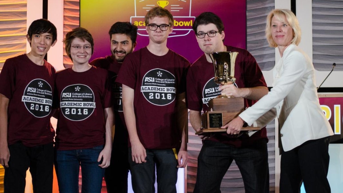 group of students posing with trophy