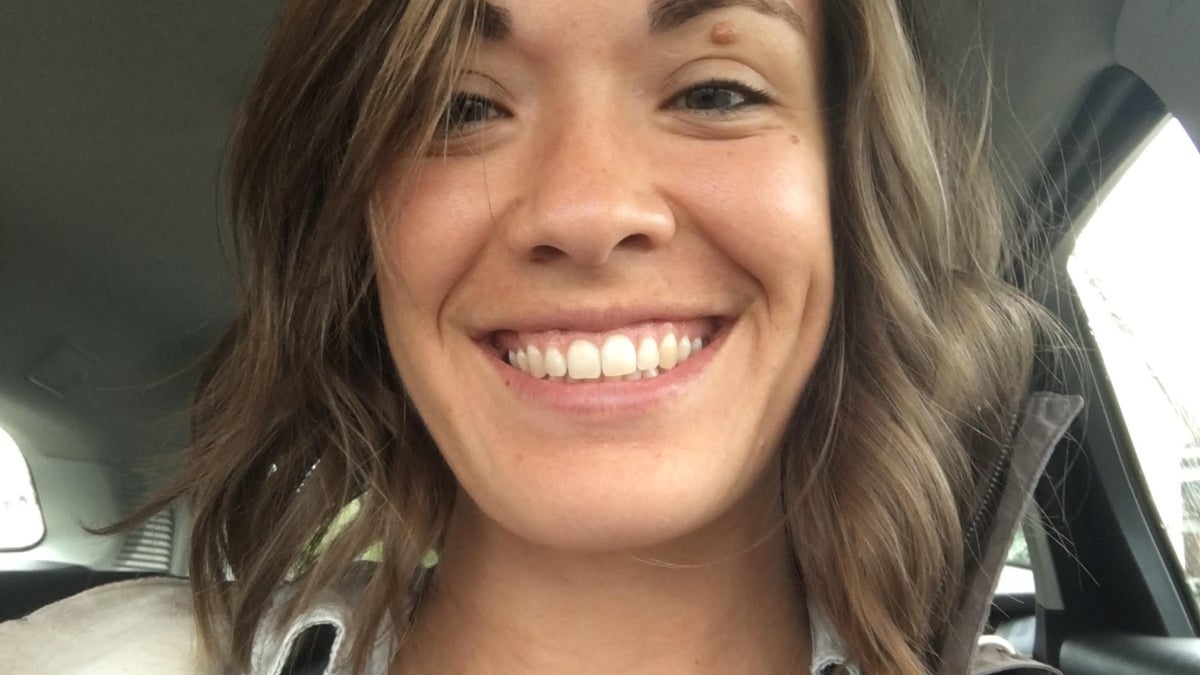 Graduating ASU student Alisa Bozich smiling at her camera from inside a car.