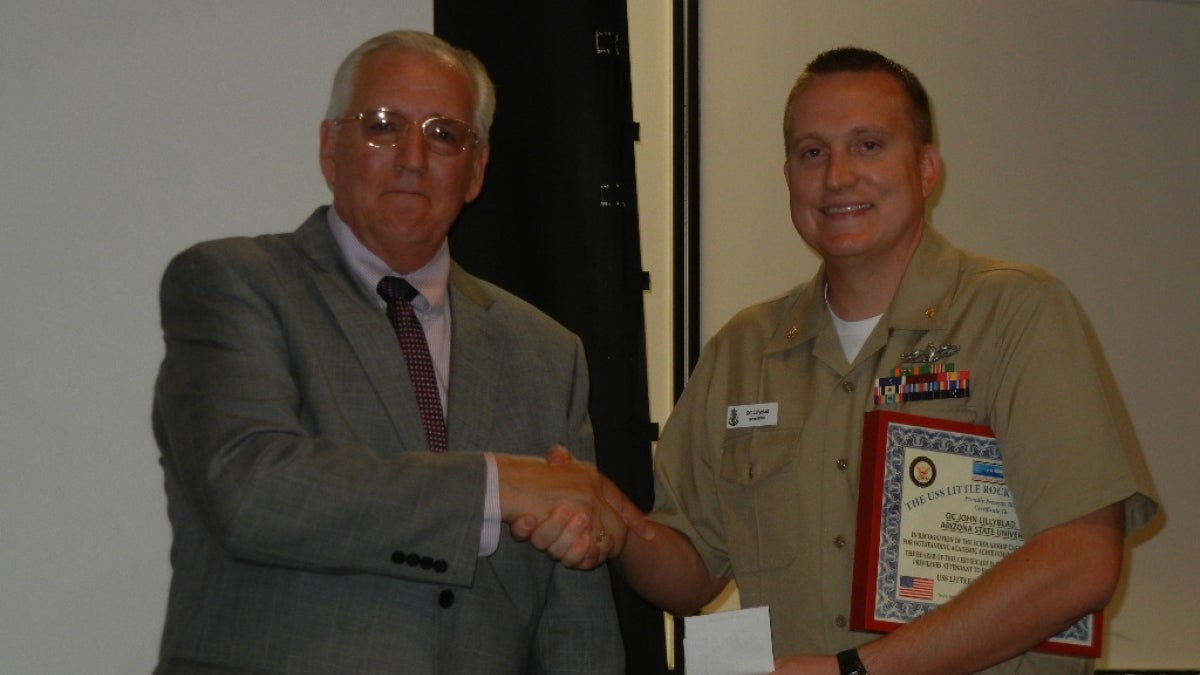 ASU&#039;s John Lillyblad shakes the hand of Retired Lieutenant Commander Bob Baker 