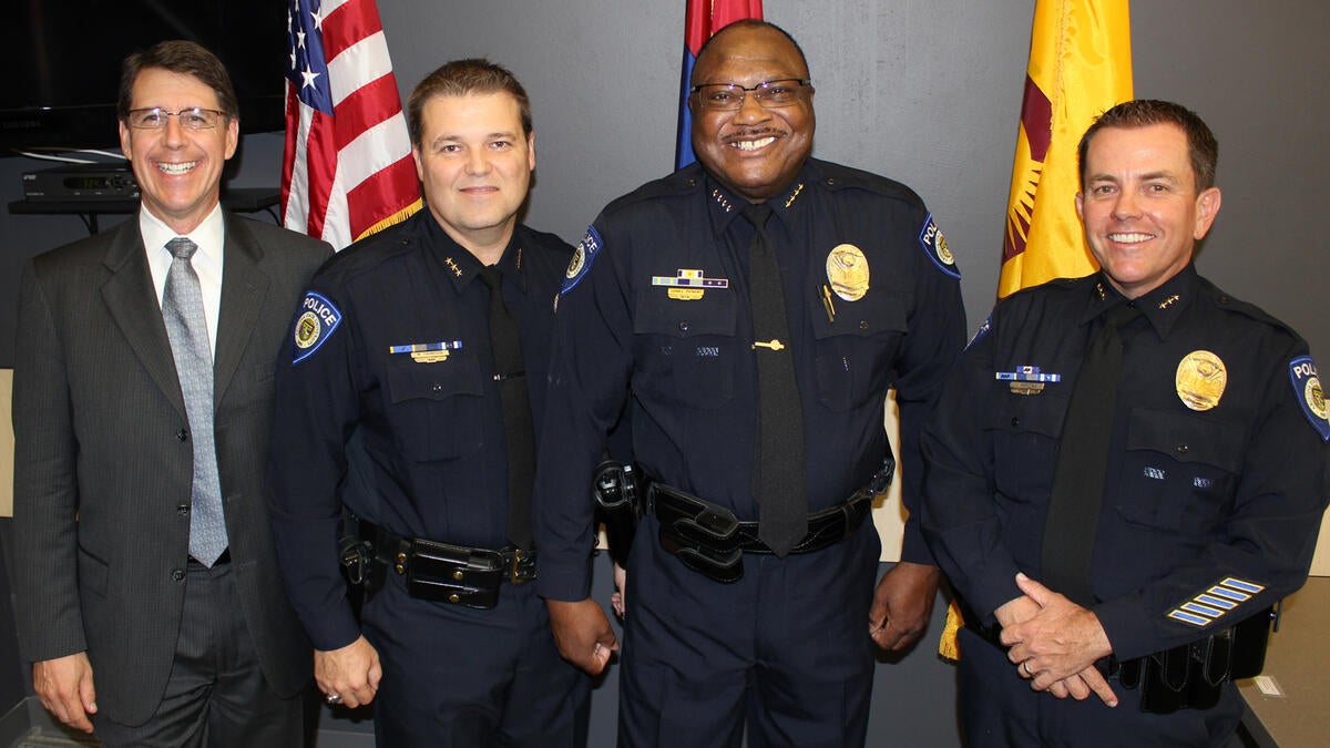 Four men pose for the camera. 