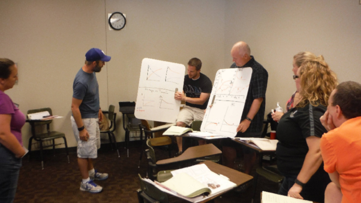 Teachers in an ASU Modeling Workshop collaborate to build a scientific model from their lab investigation data. Photo courtesy of Jane Jackson, Arizona State University.