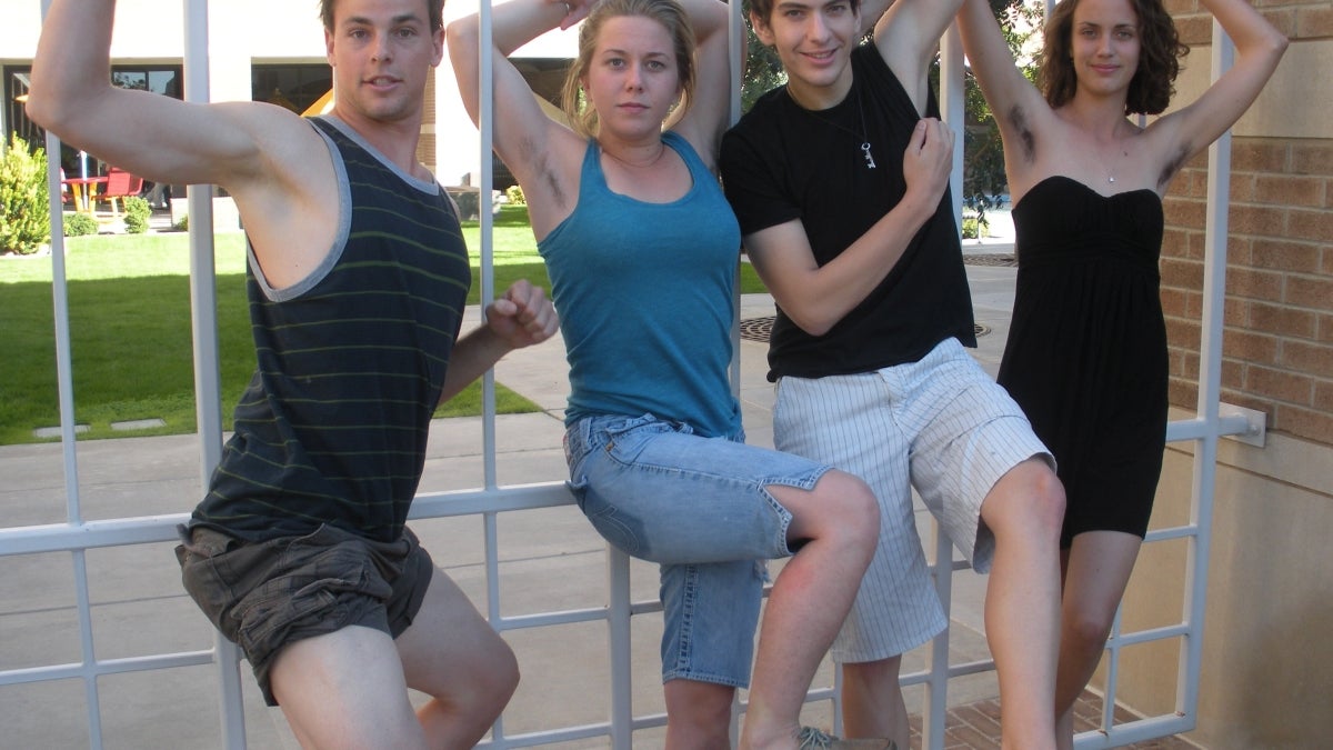 four students posing on campus