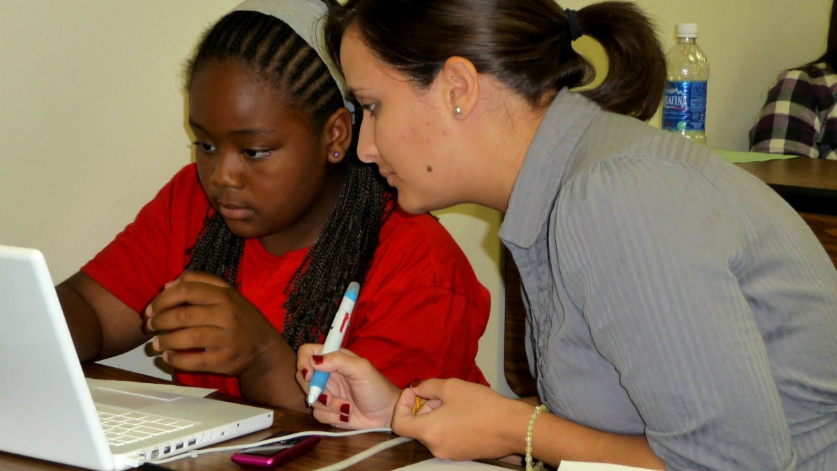 COMPUGIRLS mentor-teacher and student working at a computer