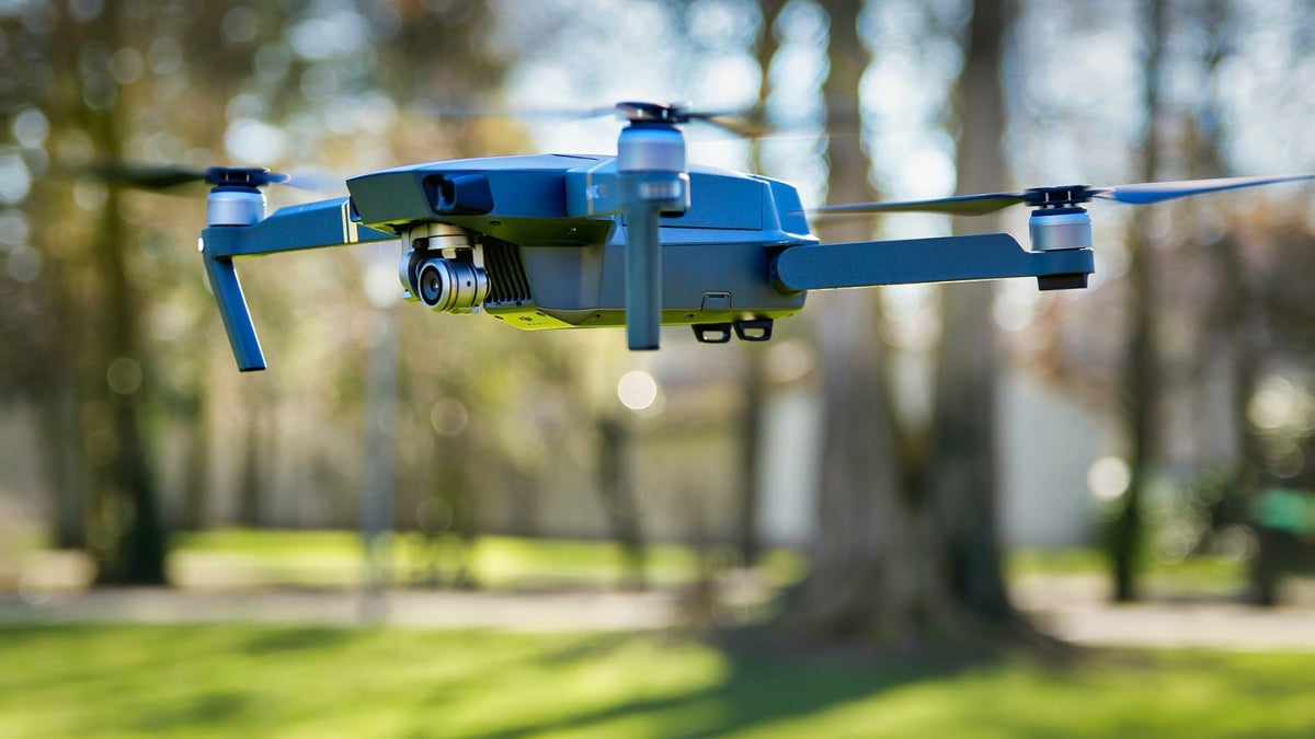 drone taking off in a park