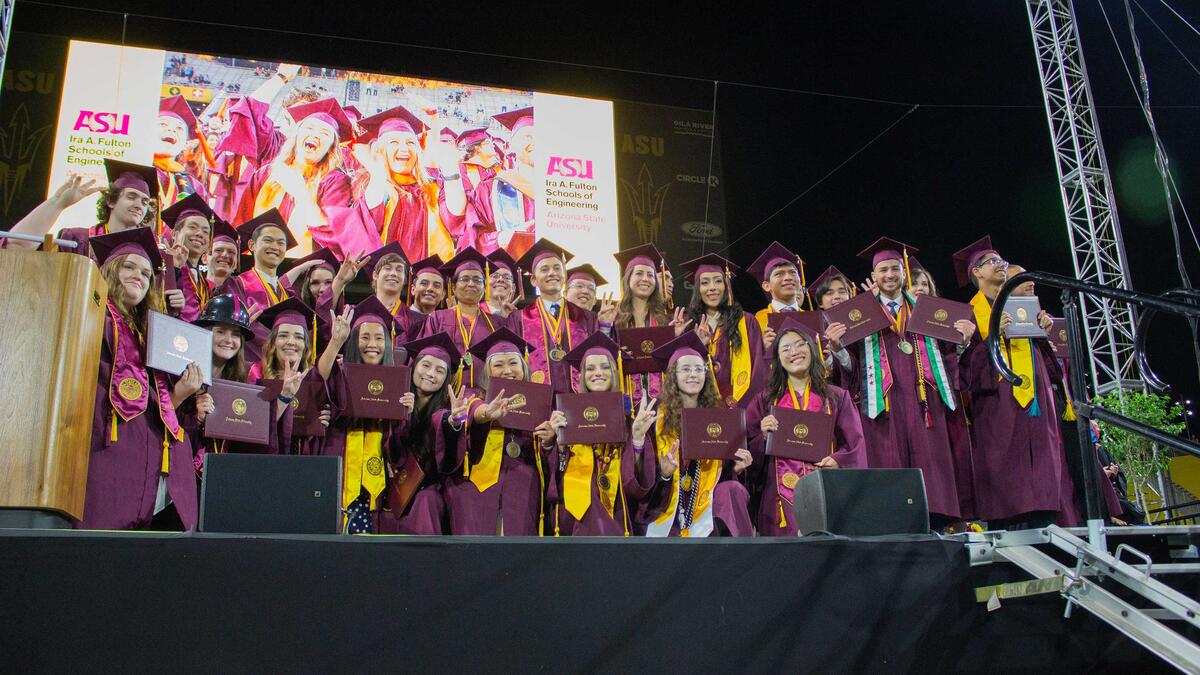 Engineering students celebrating on stage at graduation