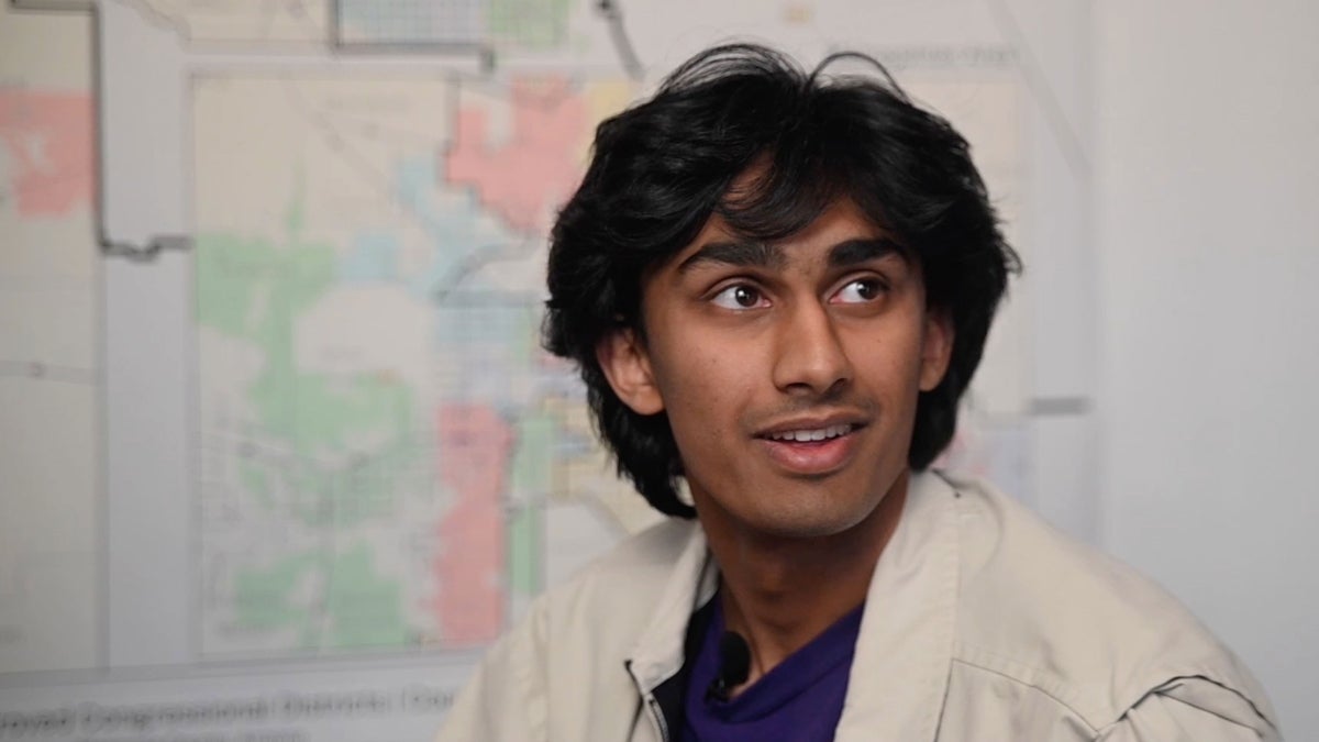 Portrait of student in front of city map