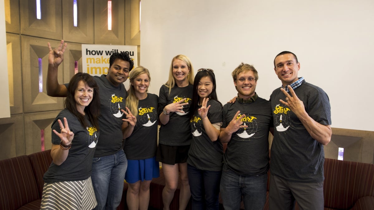 group of students showing ASU pitchfork sign