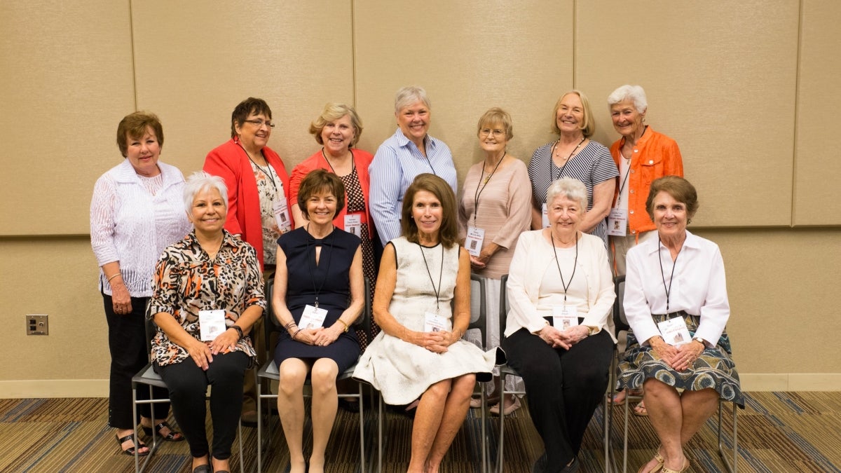 Nursing graduates from 1968 pose for a photo, some are seated, some are standing.