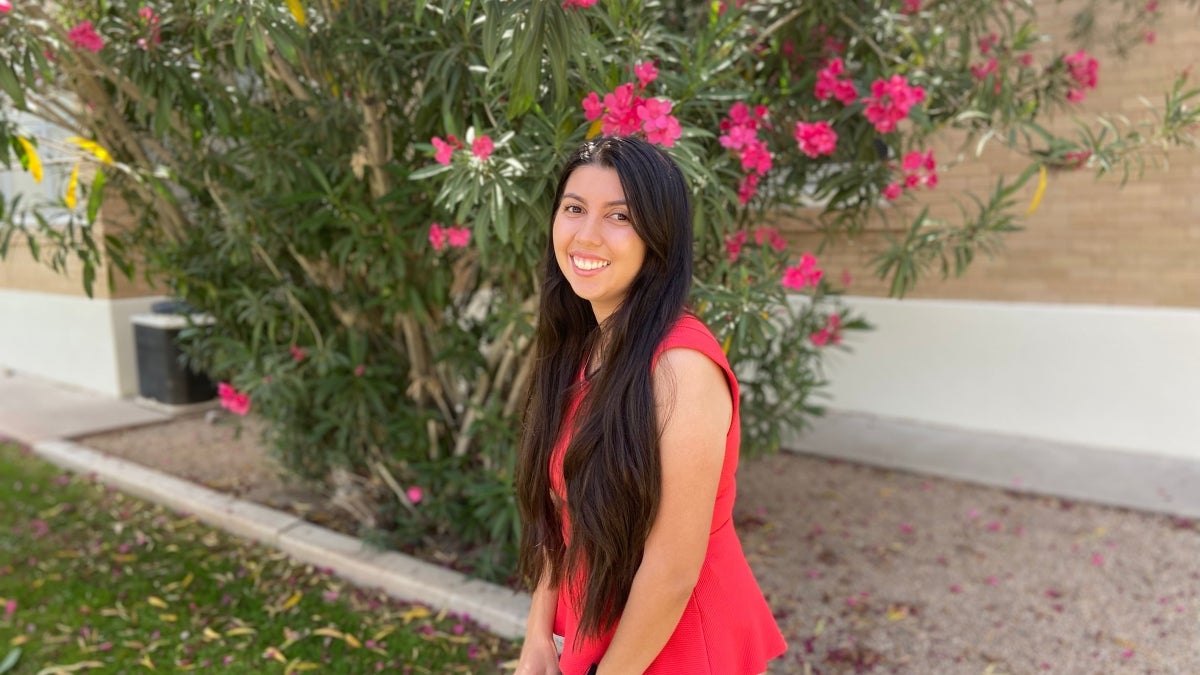 ASU College of Integrative Sciences and Arts master of counseling graduate Lisa Gutierrez outdoors in front of blossoming oleander