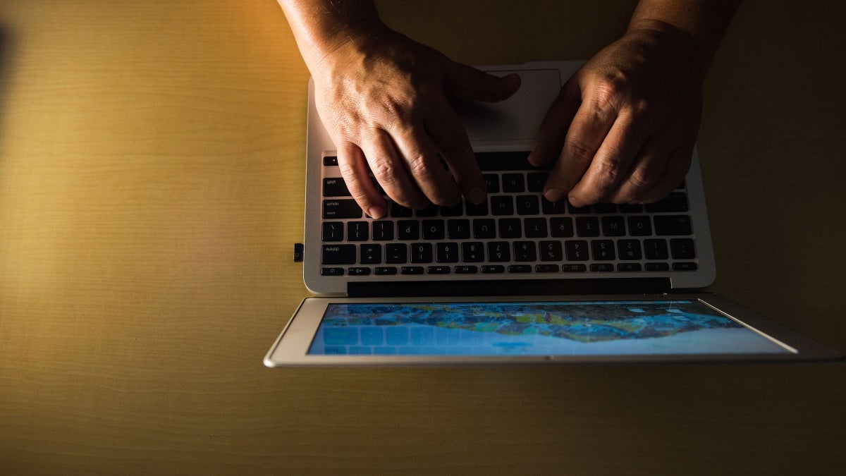 A pair of hands on a keyboard