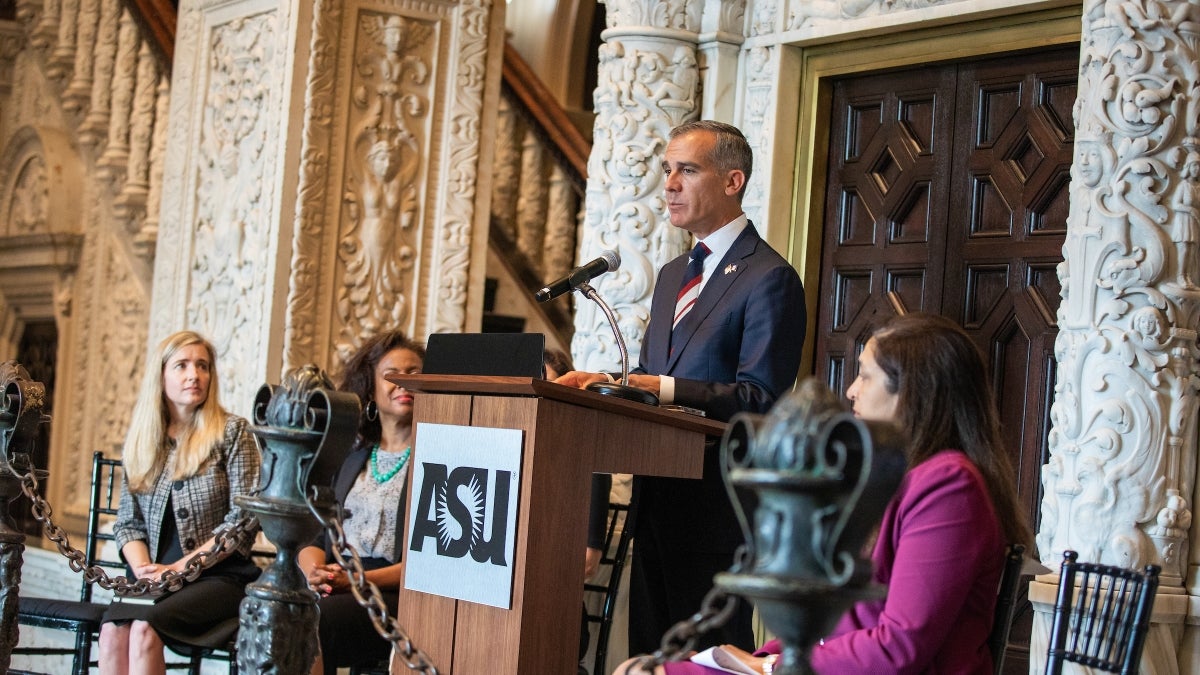 A man speaks at a lectern