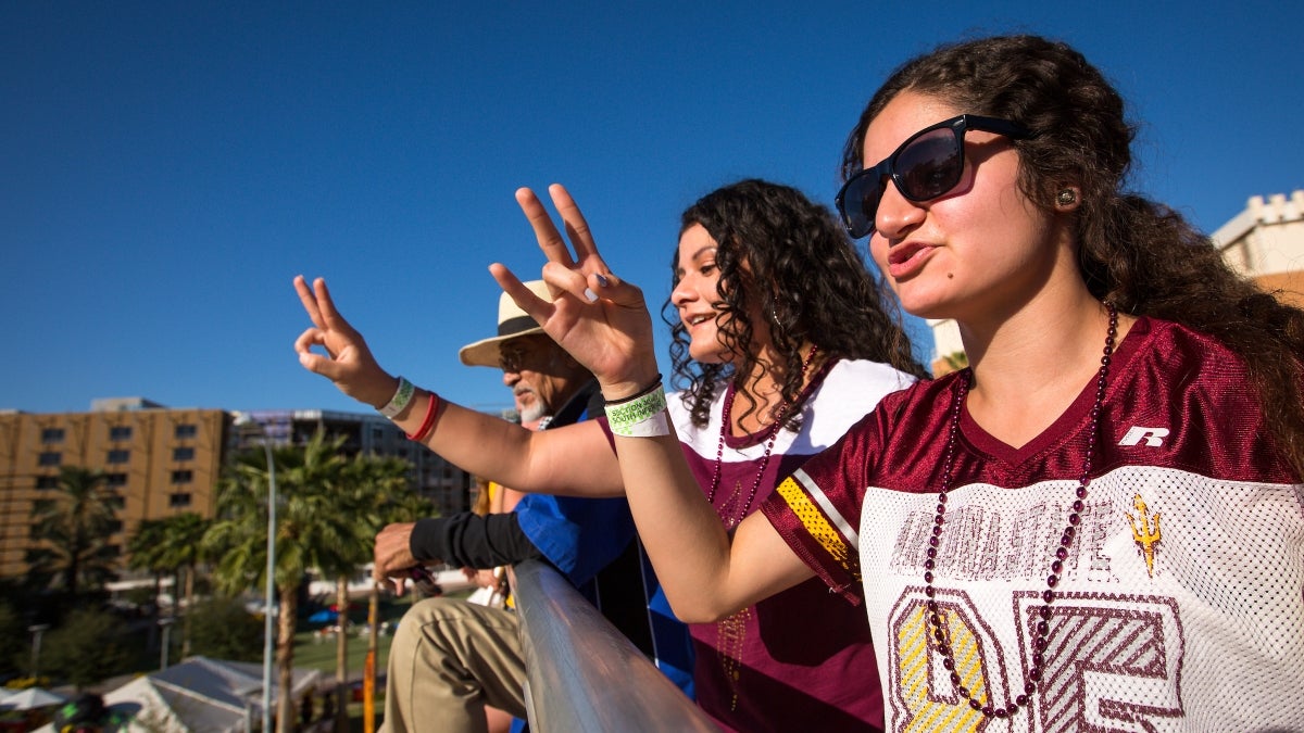 Fans cheer during the ASU Homecoming Parade.