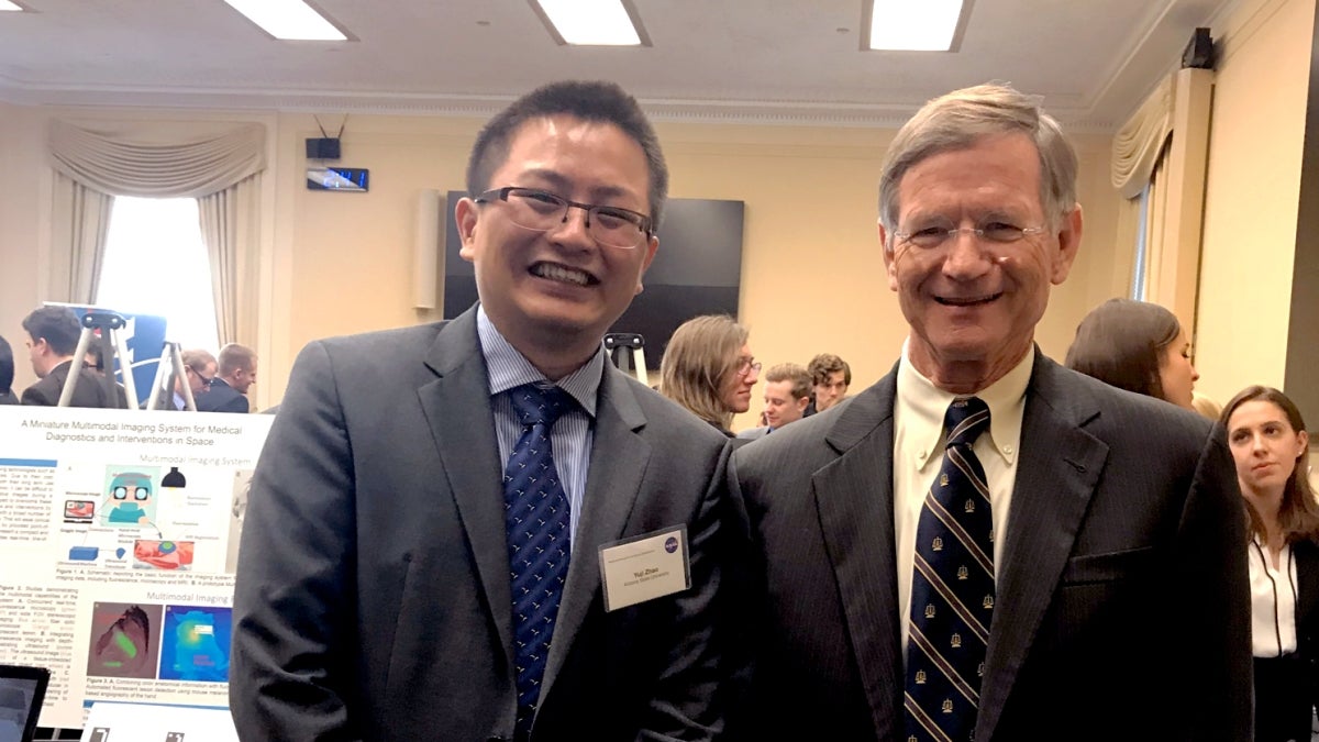 Yuji Zhao (left) poses with U.S. Representative Lamar Smith, chairman of the Committee on Science, Space, and Technology.