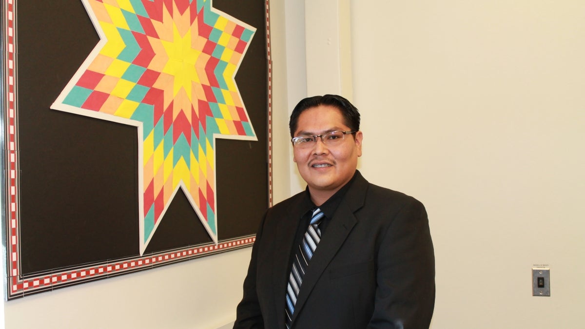 man standing in front of mural