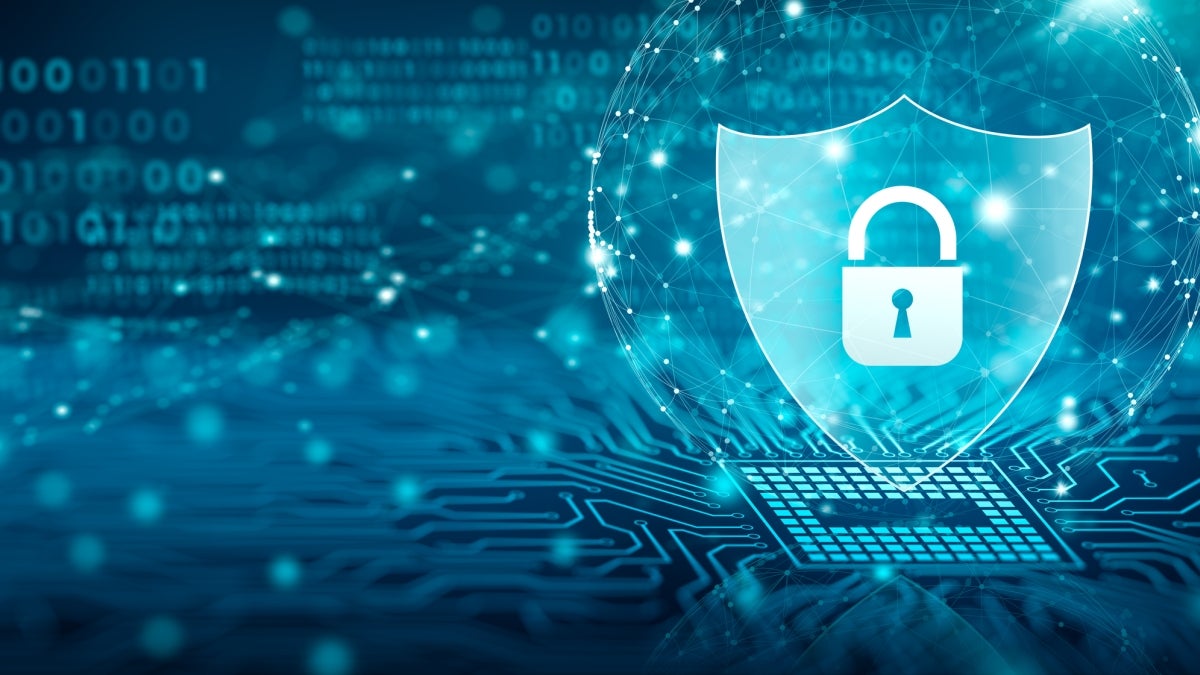 Graphic of a lock on a shield with coding and computer chips around it.