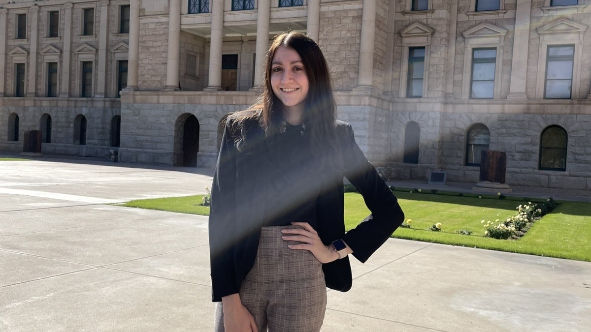 ASU grad Madison Woerner poses outside of the Arizona State Capitol