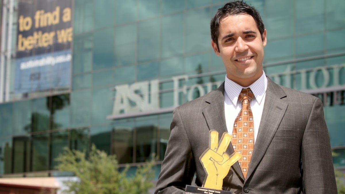 Student Max Scott poses holding Pitchfork Award