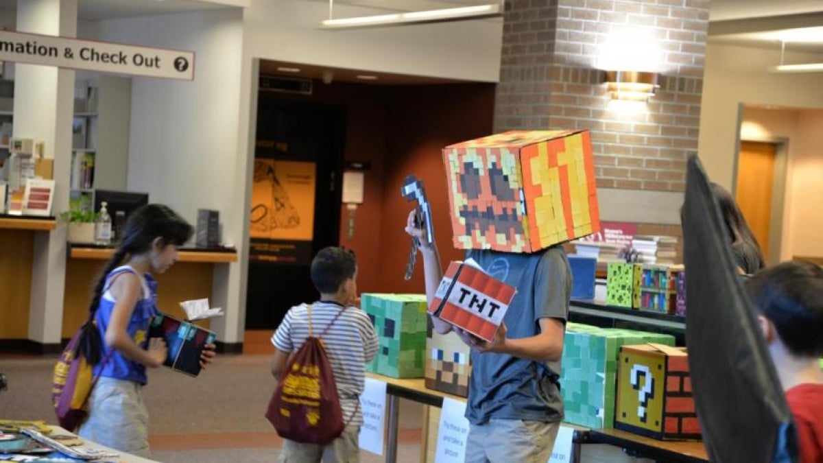 A child wears Minecraft costume pieces.