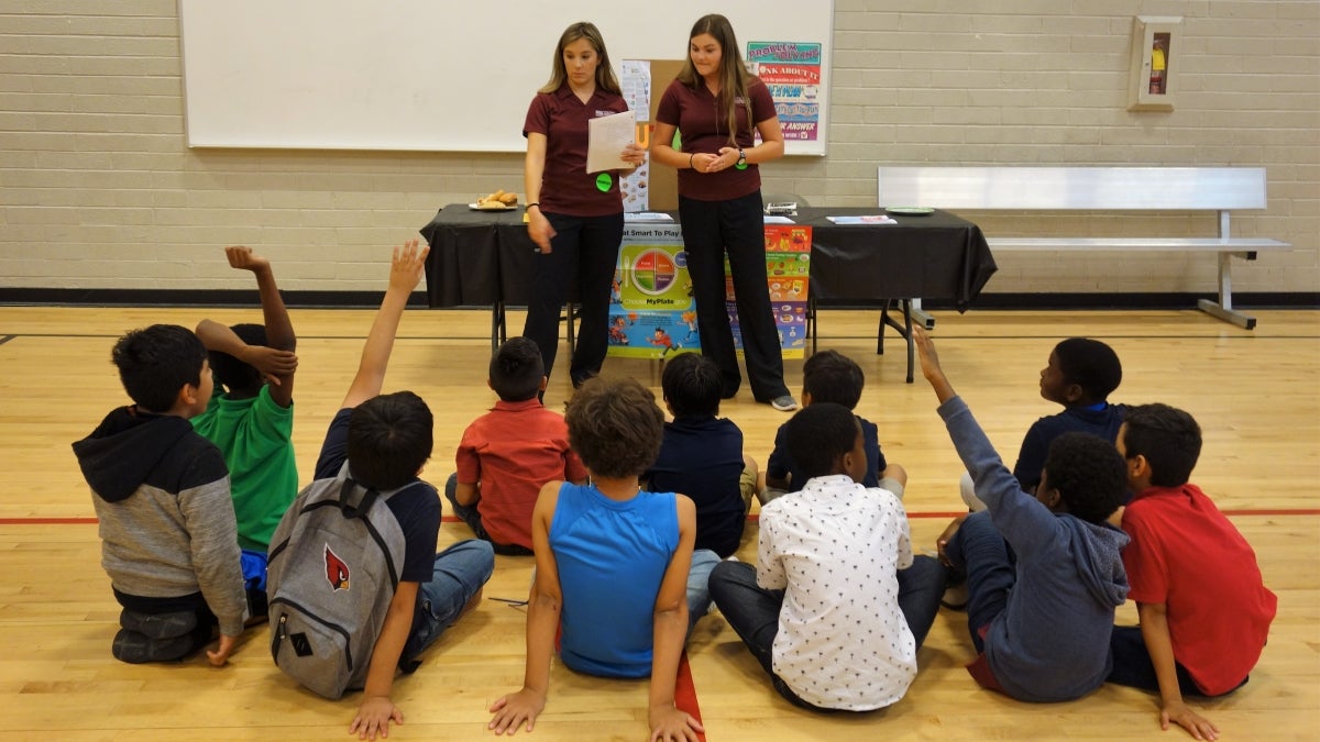 ASU nursing students answer questions at a health fair they organized