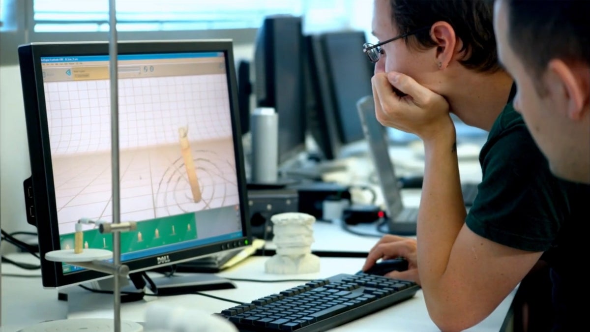 students looking at computer