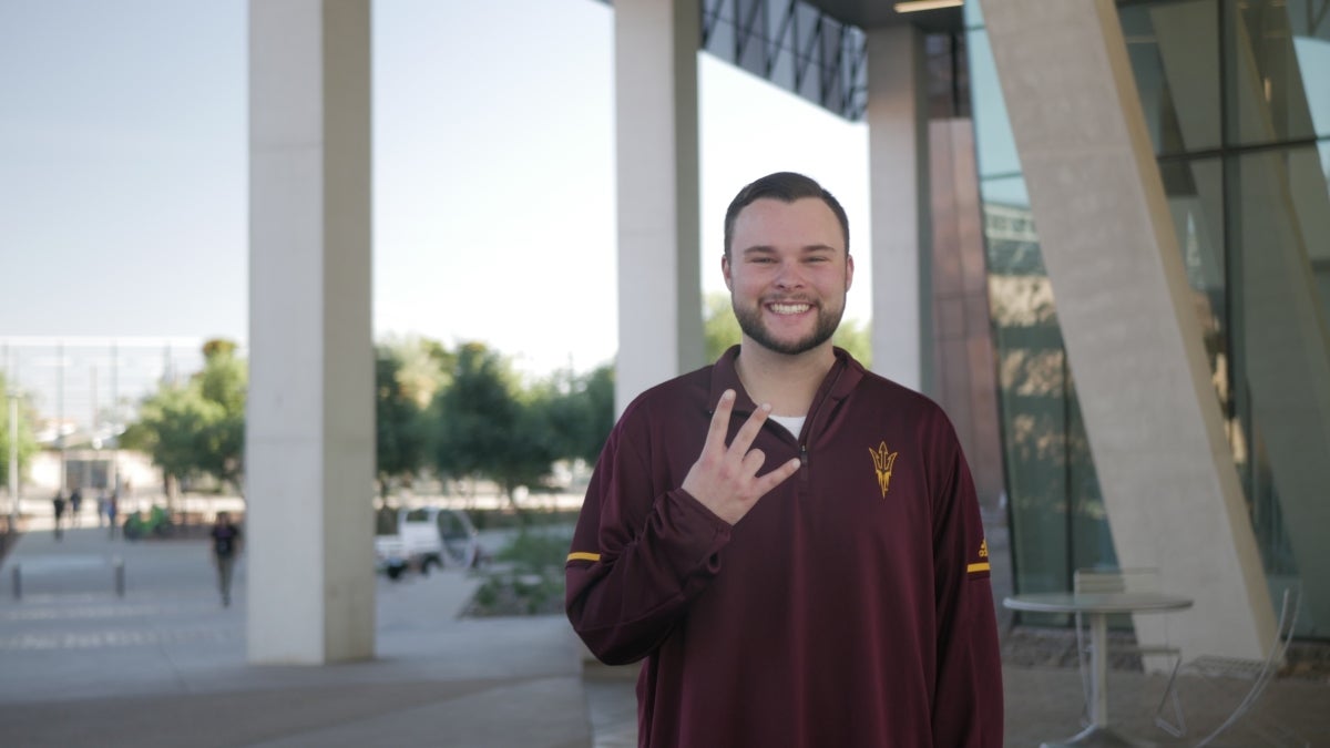 Student doing 'forks up' gesture.