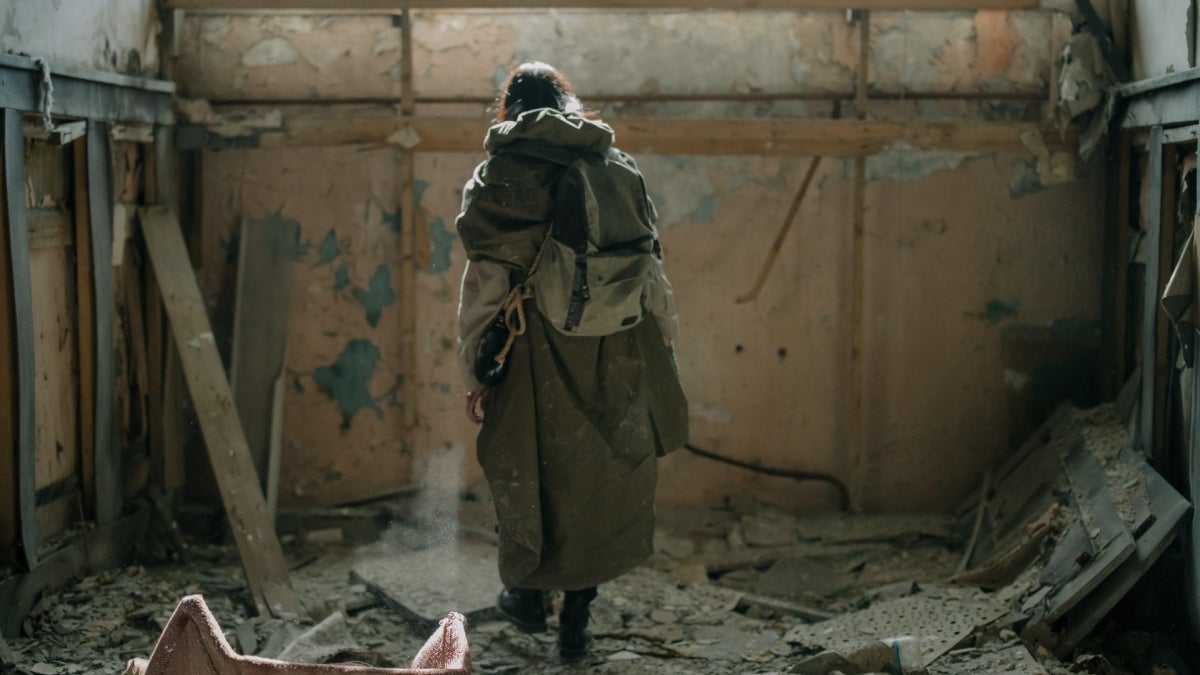 lone woman in ruined building