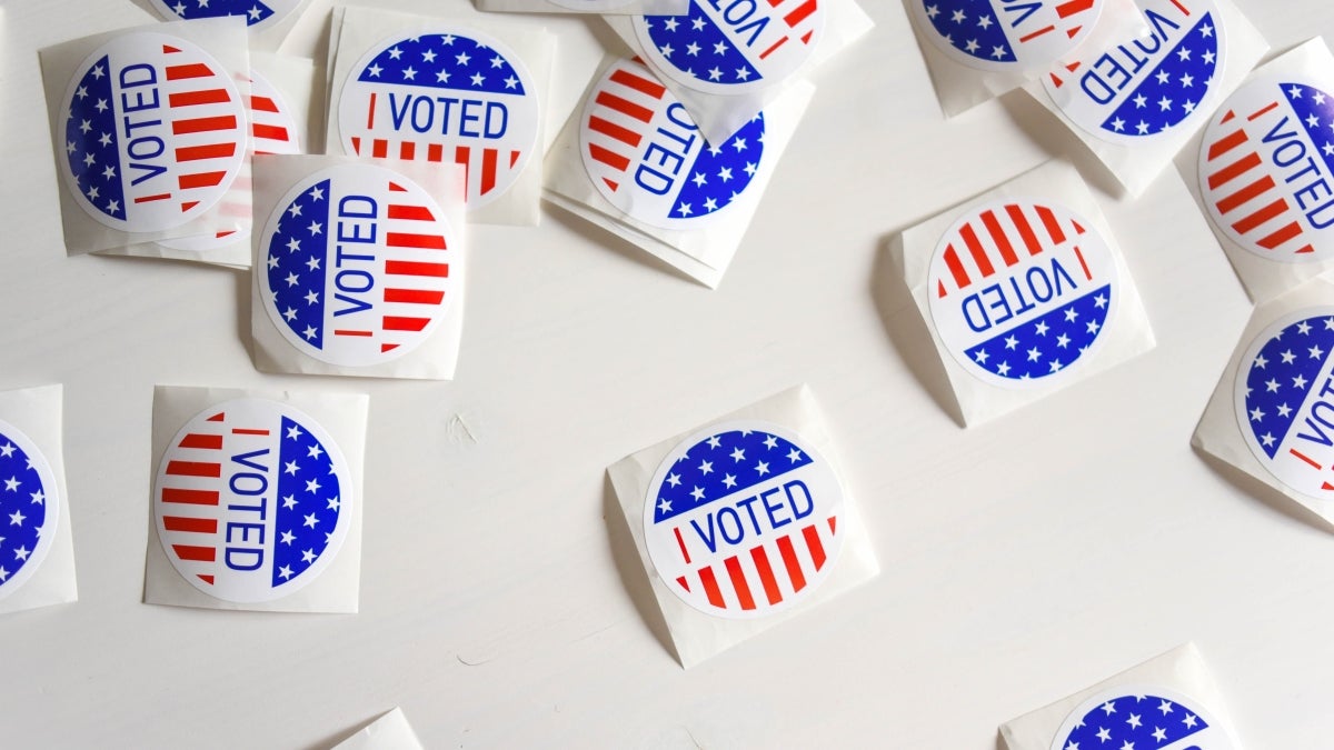 Vote stickers scattered on a white surface