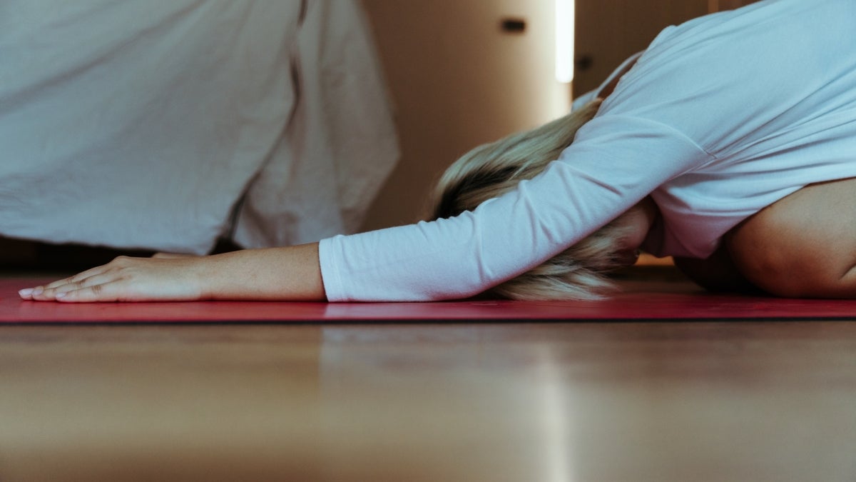 young woman in yoga child's pose