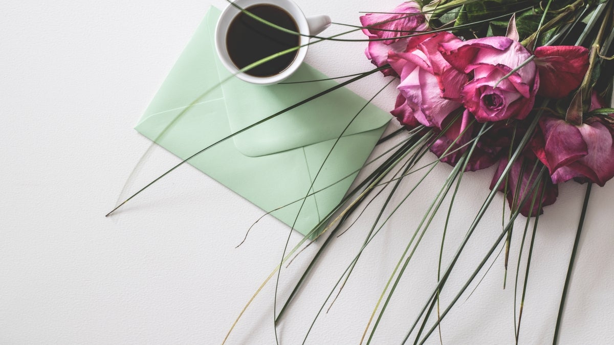 Flowers, card and coffee on a table